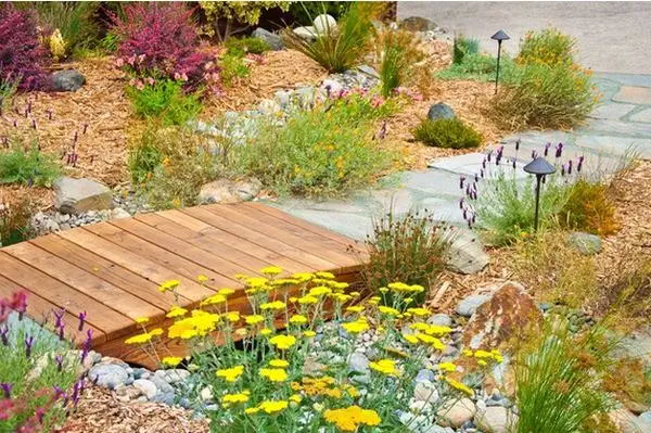 backyard-flowers-wood-arched-bridge
