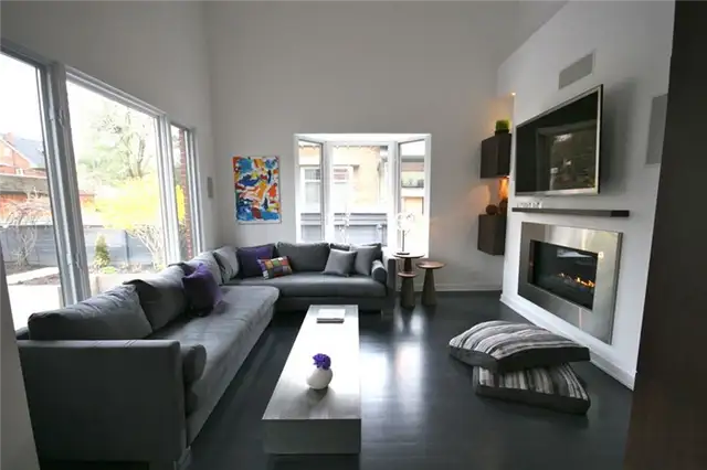 modern-living-room-with-fireplace-and-tv-above-floor-pillows-around