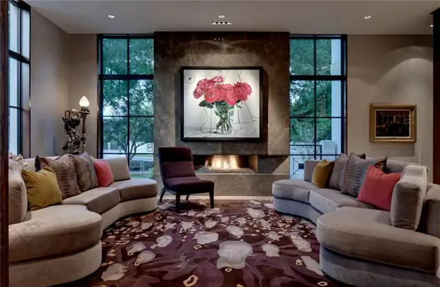 texas-living-room-fireplace-with-roses-wall-art-above-and-bold-cherry-carpet
