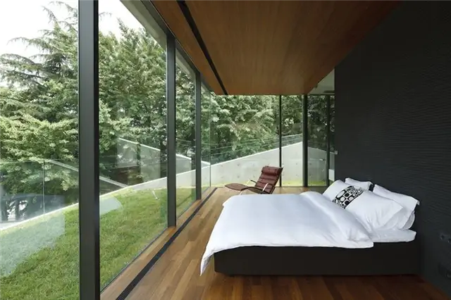 Спальня с окнами от пола до потолка от Apollo Architects & Associates